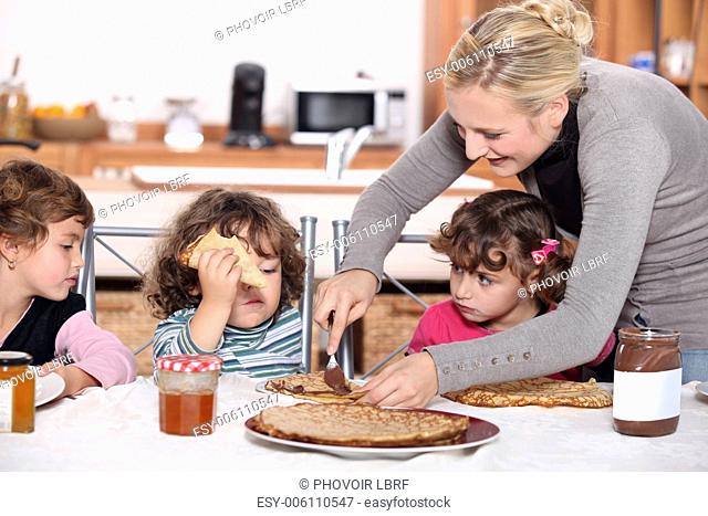 Mother preparing breakfast for kids