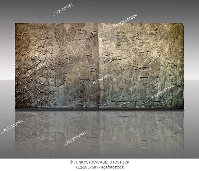 Assyrian relief sculpture panel of King Ashurnasirpal flanked by eagle headed protective spirits, from Nimrud, Iraq. 865-860 B