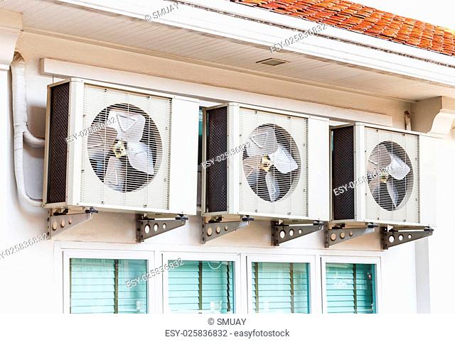 Close up air conditioners installation outside of building near glass windows