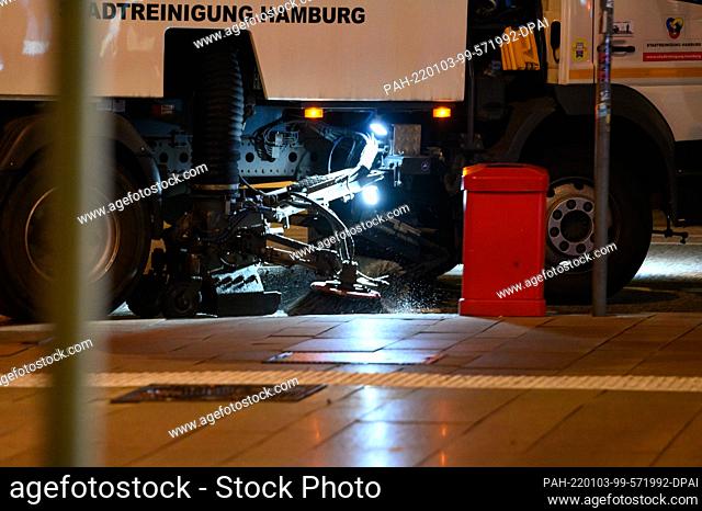 01 January 2022, Hamburg: A sweeper drives over the Neuer Jungfernstieg in the early morning. New Year's Eve in Hamburg was much quieter than usual due to...