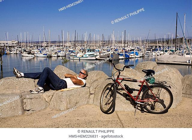 United States, California, Monterey Peninsula, Monterey, Marina, a man making a nap and bike
