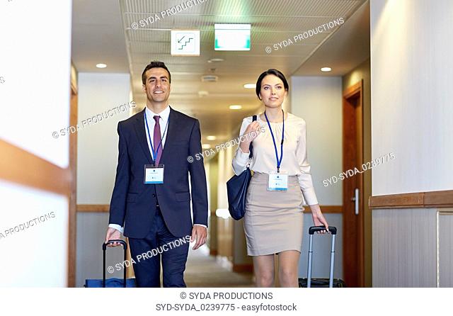 business team with travel bags at hotel corridor