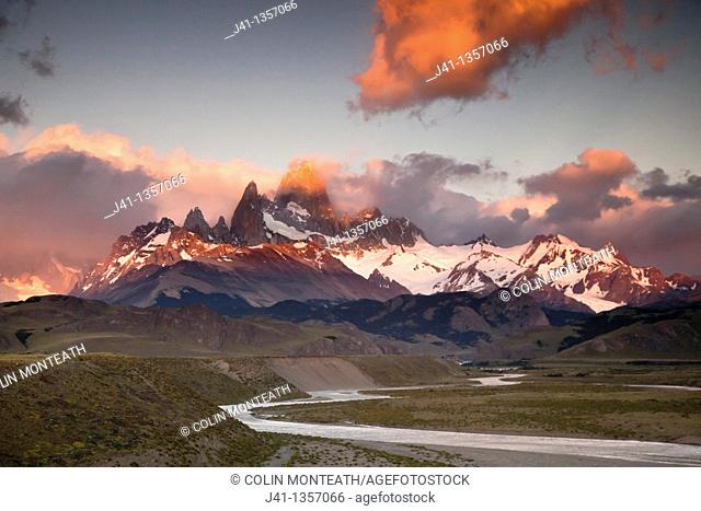 Dawn light catches rain clouds over Cerro FitzRoy, view from La Quinta estancia, edge Parque Nacional Los Glaciares, Patagonia, Argentina
