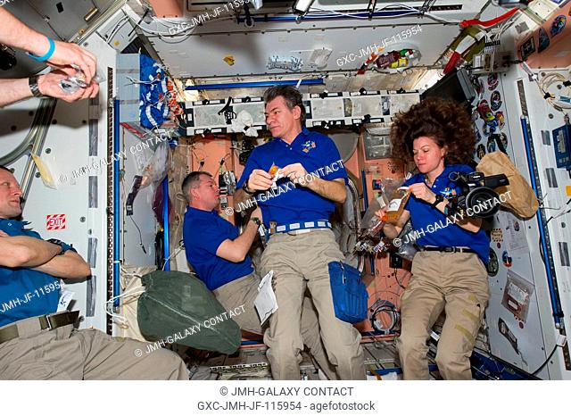 A cosmonaut and two astronauts representing three different organizations but the same International Space Station expedition crew