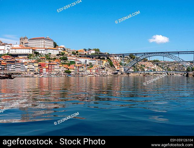 Cityscape of Porto from the banks of the river Douro with artificial water