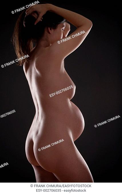 nude pregnant woman with long brown hair
