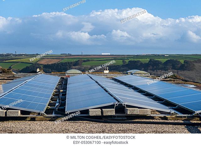Solar panels on the roof of a building generating clean renewable electrical energy