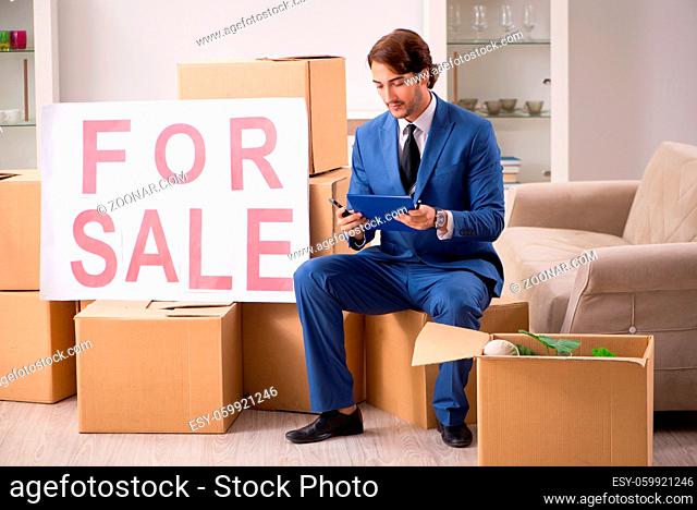Young handsome realtor selling flat