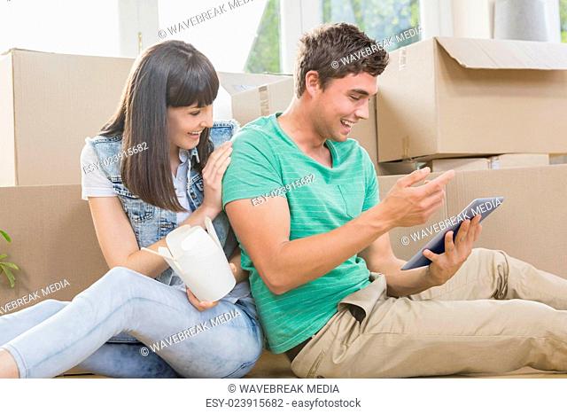 Young couple eating noodle and using digital tablet