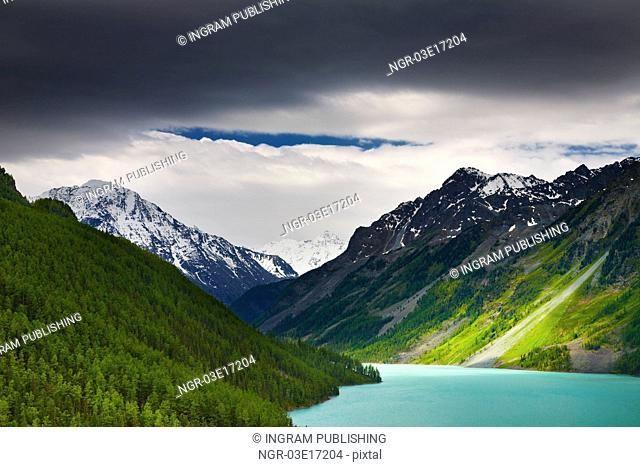 Mountain landscape with lake and storm clouds