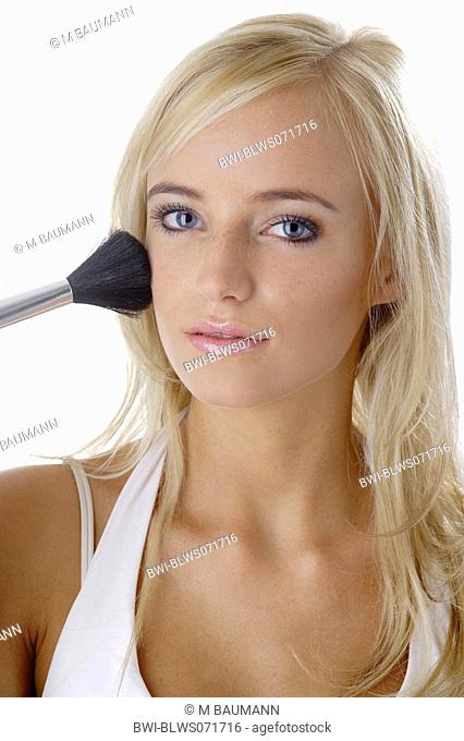 female model with cosmetic brush