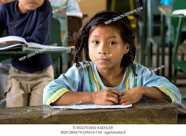 Elementary school girl in the classroom at the Kichwa native community O El Pilchi near La Selva Lodge near Coca, Ecuador