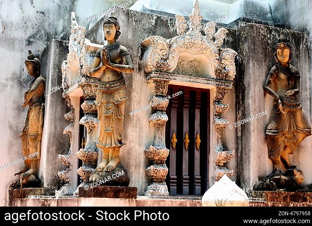 Buddha sculptures in an ancient buddhist wat in Thailand