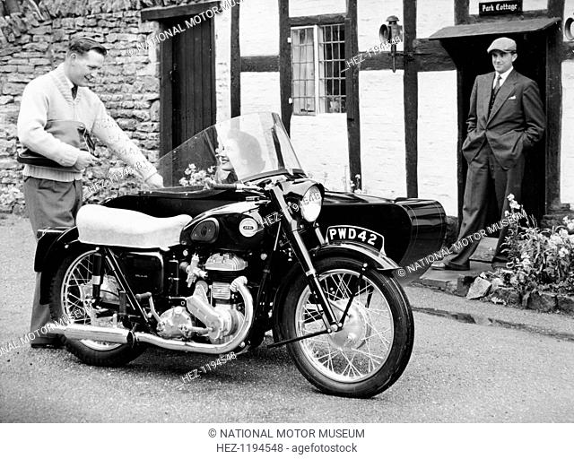 An Ariel VB 600cc with a sidecar, 1956. Parked outside a cottage, with a smiling woman sitting in the sidecar. The company was founded by James Starley and...
