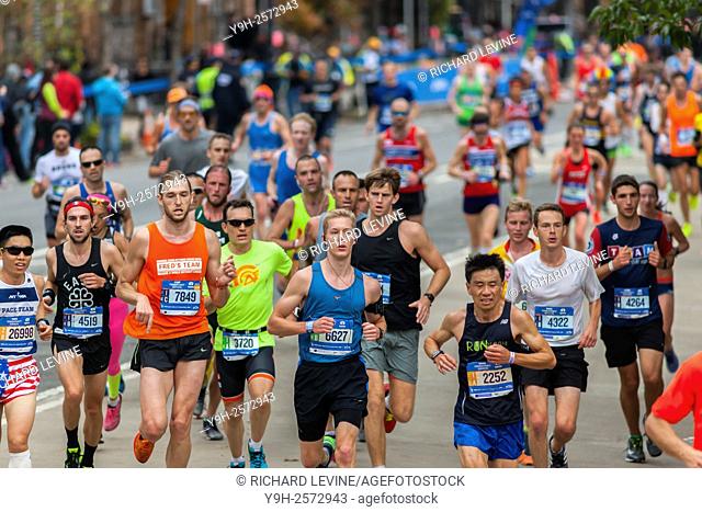 Runners pass through Harlem in New York near the 22 mile mark near Mount Morris Park on Sunday, November 1, 2015 in the 45th annual TCS New York City Marathon