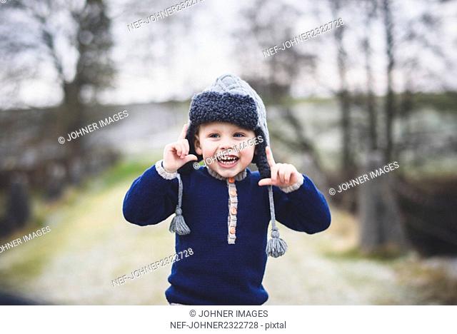 Small boy wearing fur hat