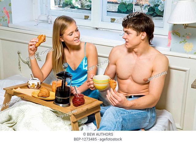 Young couple spending time together in bed