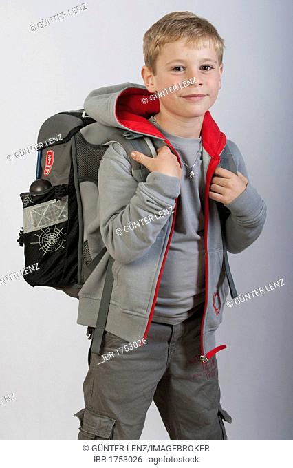 6 year old boy with a school bag, first grade school child