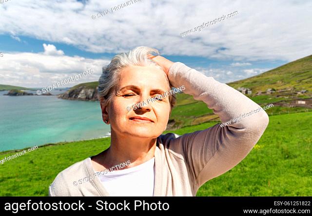 portrait of senior woman enjoying sun on beach