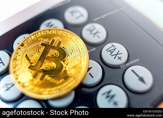 Bitcoin coin with calculator as a tax payment concept