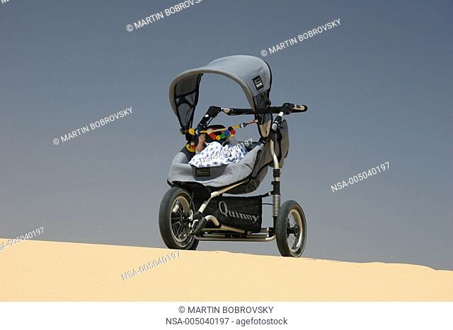 baby carriage in desert