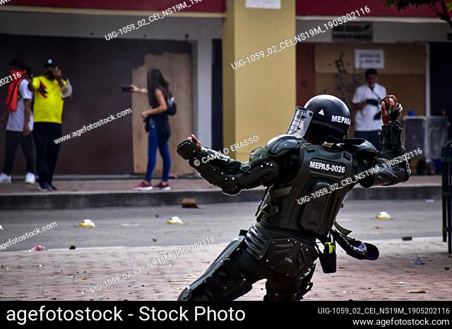 Riot police member throw a rock at demostrators in Pasto, Narino on May 19, 2021 during an antigovernment protest against police brutality and the health reform...