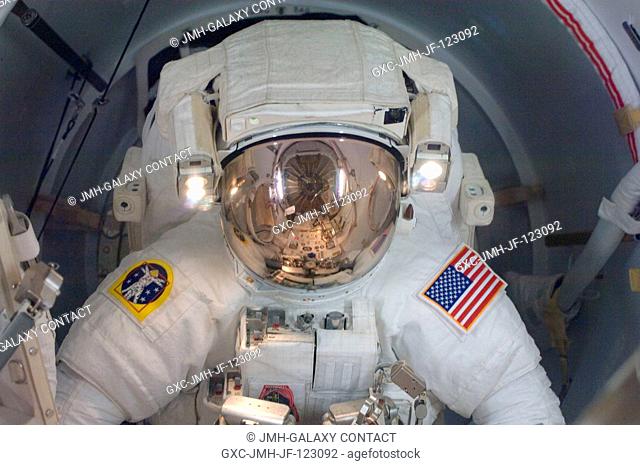 Astronaut Joseph Acaba, STS-119 mission specialist, attired in his Extravehicular Mobility Unit (EMU) spacesuit, enters the Quest Airlock of the International...