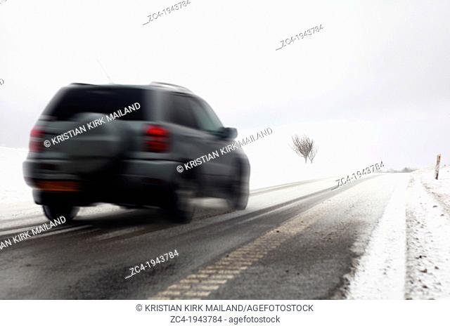 Fast car on snowy winter road