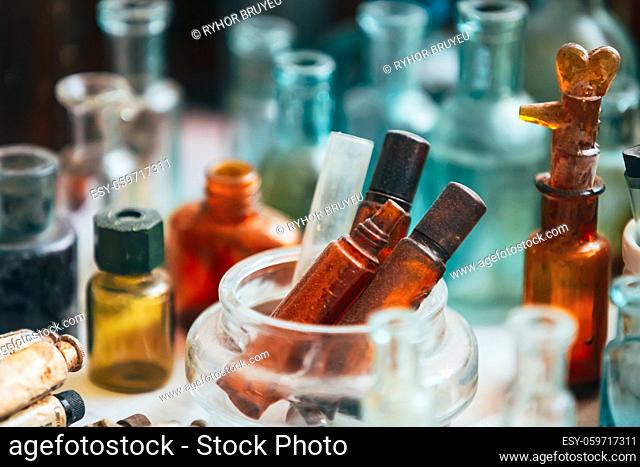 Many Old Medical Glass Capacity. Detail Of Retro Chemical Pharmaceutical Science Researches. Many Small Vintage Bottles And Glassware Different Sizes And Colors