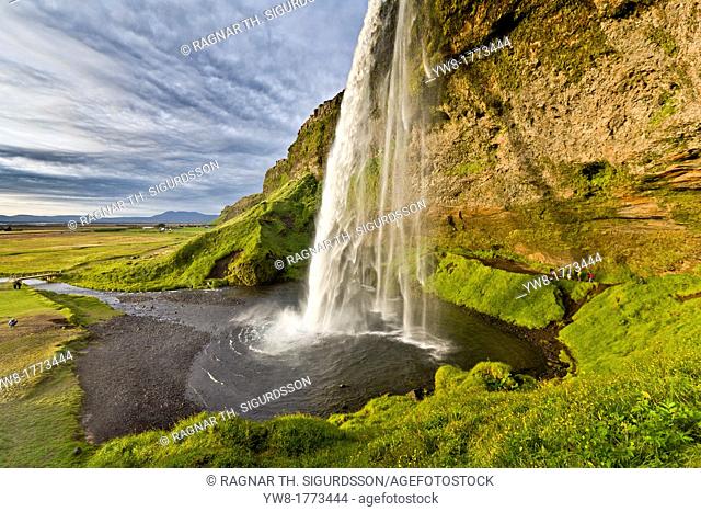 Seljalandsfoss Waterfall, Iceland This waterfall drops 60 metres 200 ft over the cliffs  There is a trail behind for easy access to walk behind the falls