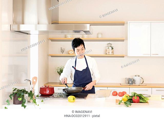 Senior woman cooking with tablet PC