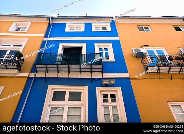 Low Angle View of Colorful Building Exteriors with Paned Windows and Small Balconies, Valencia, Spain