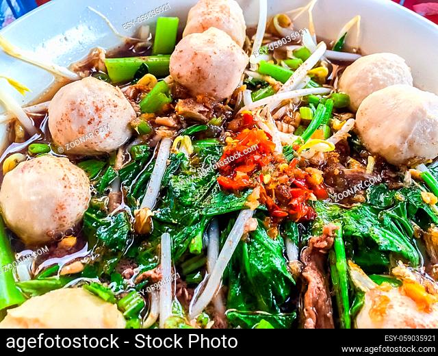 Popular street food in Thailand (Kuai Tiao Moo Namtok) that consisted of pork ball, pork meat, basil or thyme, bean sprouts, morning glory