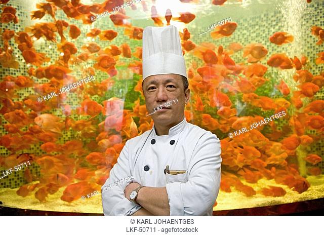 restaurant chef infront of aquarium
