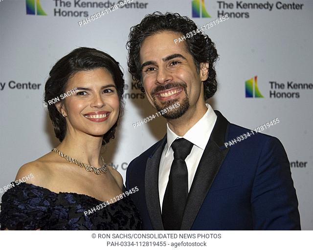 Alex Lacamoire and and his wife, Illeana Ferreras, arrive for the formal Artist's Dinner honoring the recipients of the 41st Annual Kennedy Center Honors hosted...