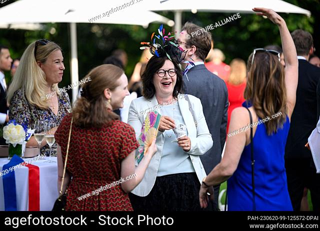 20 June 2023, Berlin: Guests enjoy themselves at the birthday party for King Charles III in the garden of Villa Ullstein