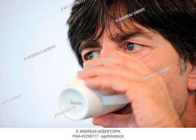 Head coach of the German national soccer team Joachim Loew drinks during a press conference of the German team in Munich, Germany, 04 September 2013