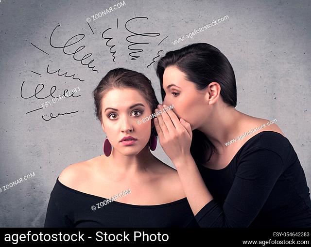 A cute teen caucasian girl telling secret things to her girlfriend dressed in black dress concept with drawn lines, curves, spirals on grey wall background