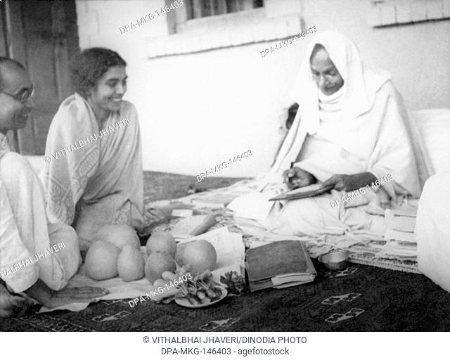 Pyarelal Nayar , Sushila Nayar laughing with Mahatma Gandhi , who is writing during his visit to Utmanzai Peshawar , North West Frontier Provinces to...