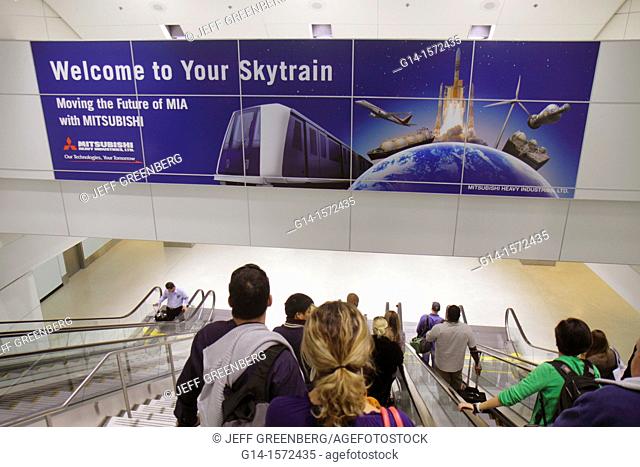 Florida, Miami, Miami International Airport, MIA, Skytrain, advertising, Mitsubishi, escalator, travelers