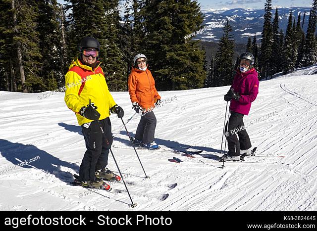 Three skiers at Silver Star ski resort near Vernon, BC, Canada
