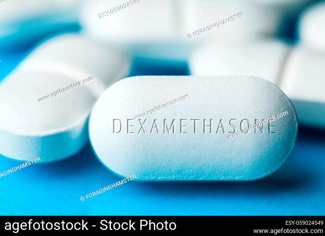 COVID-19 corticosteroid medication drug DEXAMETHASONE, pile of white pills with letters engraved on side, potential experimental WHO Coronavirus cure