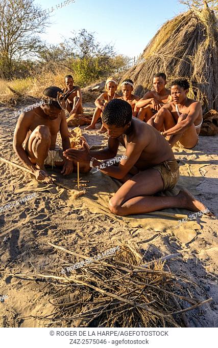 San or Bushman lighting a fire using two sticks. Haina Kalahari Lodge. Botswana