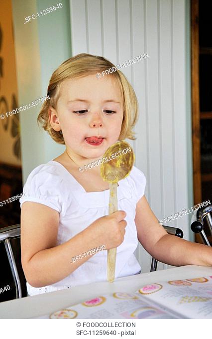 A little girl baking in a kitchen