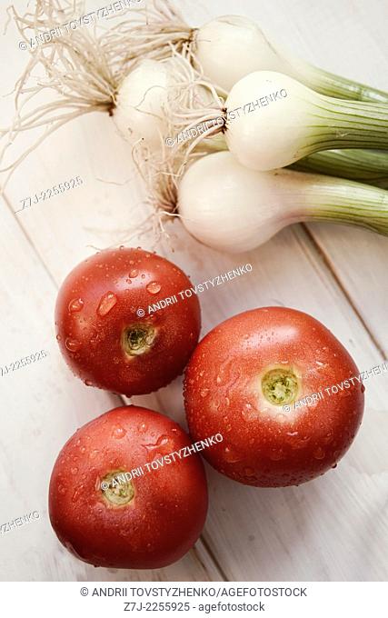three tomatoes and green onions