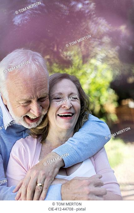 Affectionate, smiling senior couple hugging