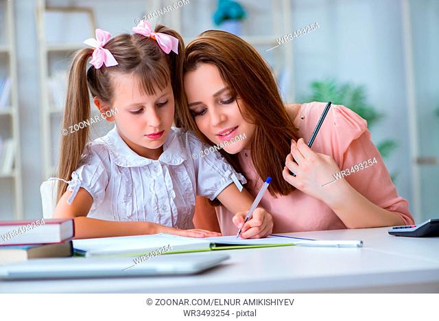 Mother helping her daughter to do homework