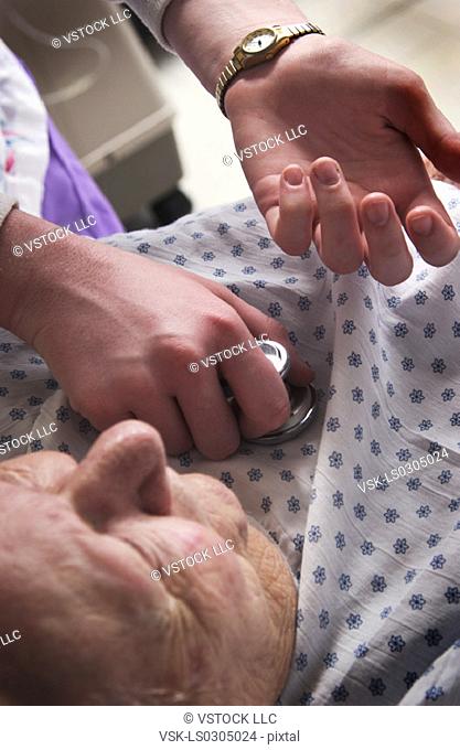 Nurse giving senior woman a checkup