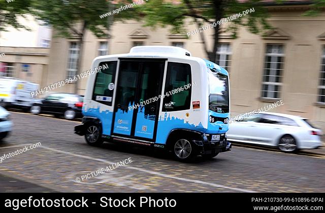 29 July 2021, Saxony-Anhalt, Magdeburg: The French EZ10 minibus, an autonomous shuttle bus, drives through the old town of Magdeburg during a test run