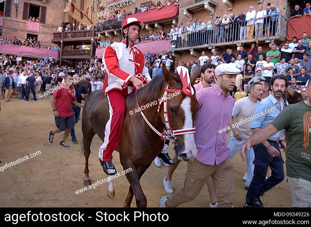 Jockeys compete at the historical horse race Palio di Siena 2022 The edition of the Assumption in Piazza del Campo. Siena (Italy), August 17th, 2022